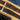 Two cork belts with silver buckles on a wooden surface.