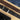 Two cork belts with engraved text on a wooden surface