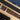 Brown cork belt with silver buckle and engraved text on a wooden surface.