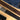 Brown cork belt with engraved text on a wooden surface