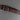Brown cork belt with a metal buckle on a gray background