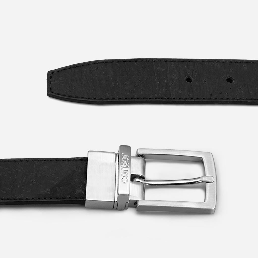 Silver-tone buckle and strap of a cork reversible belt for men.